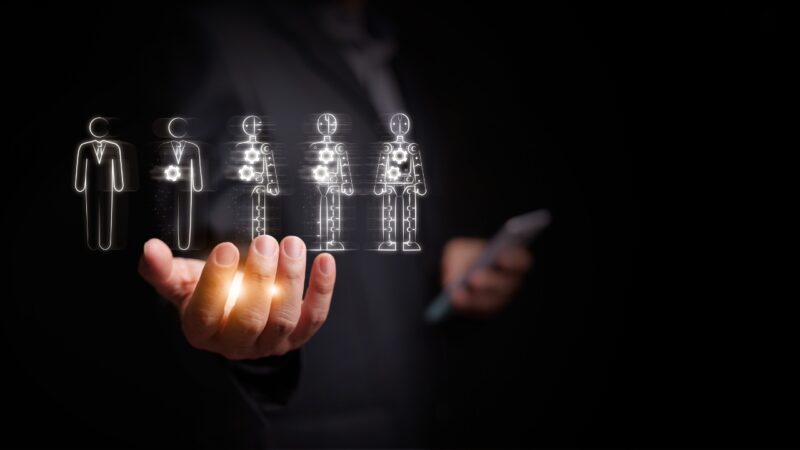 Business hand selects digital automation icons that shift human tasks toward automated review