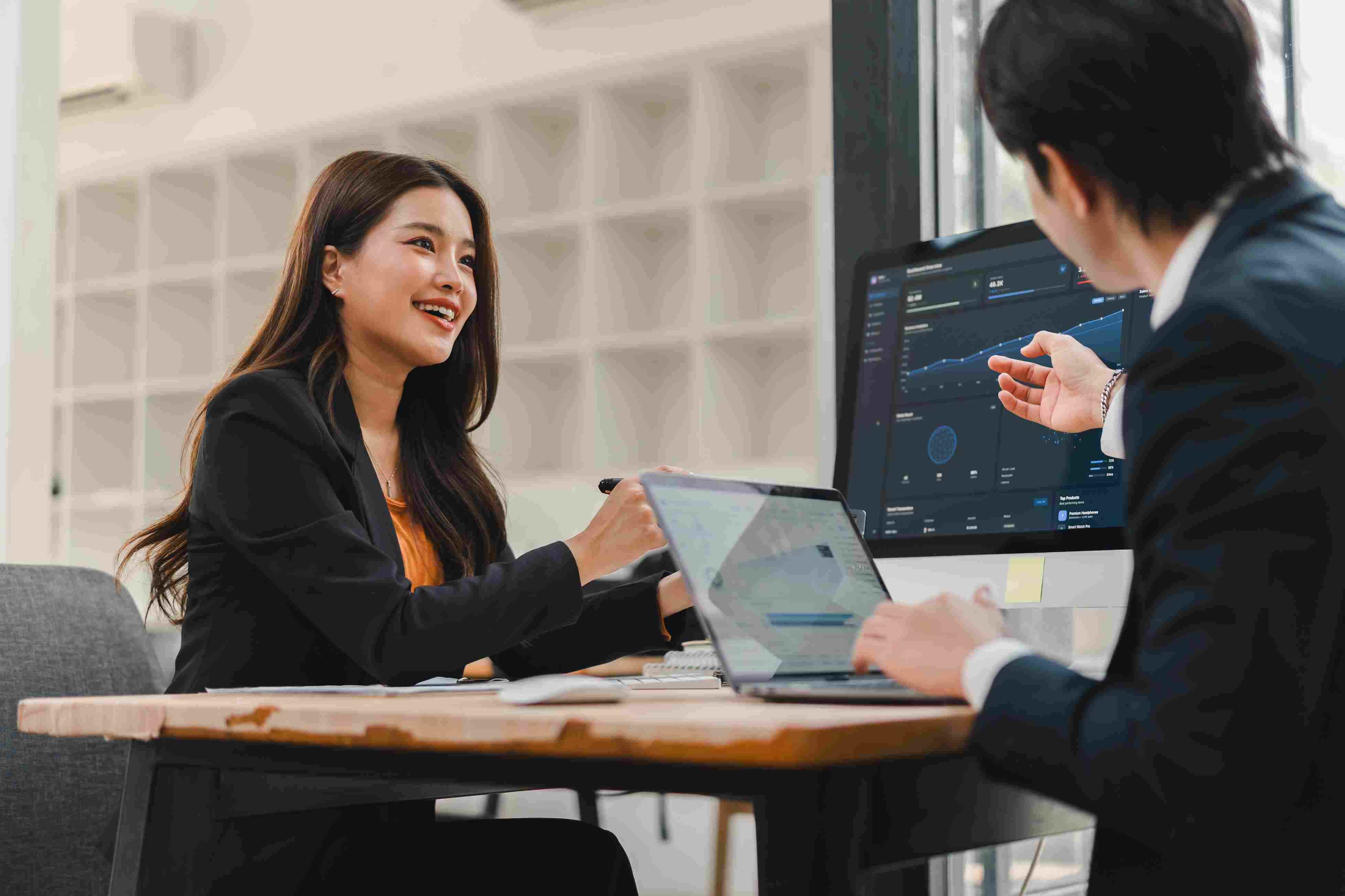 Business professionals reviewing financial data and discussing growth strategy in an office