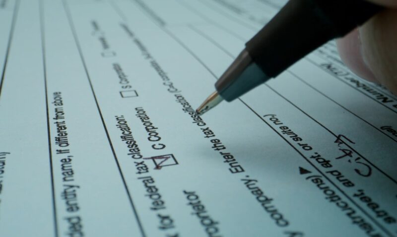 A pen writing on a tax paper