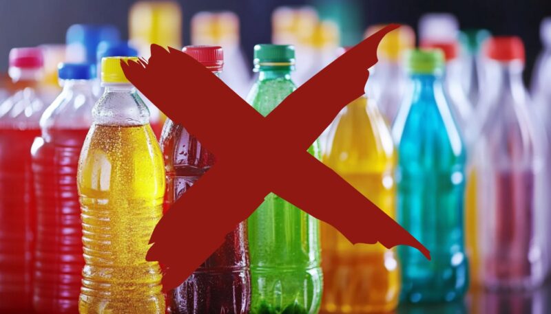 Colorful sugary drinks in plastic bottles with a large red "X" over them, symbolizing avoidance