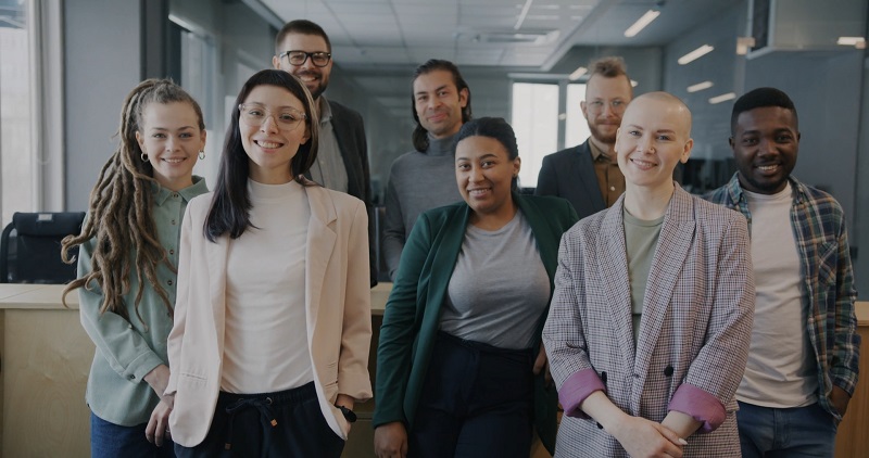 A diverse team of professionals standing confidently in an office, showcasing the importance of local talent in business expansion