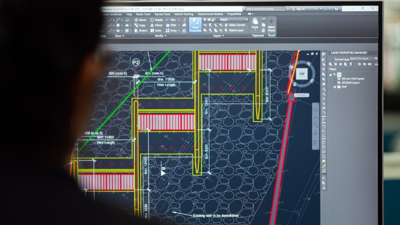 A student in STEM works with CAD software on a computer screen to design and analyze engineering projects