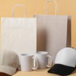 Gift bags, mugs, and caps displayed together as simple merchandise ideas for small events and conventions