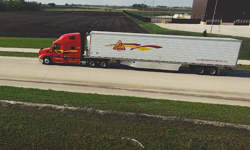 Drone view of a truck driving on the highway through Iowa state 