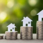 Three stacks of coins increase in height from left to right, each topped with a white house silhouette