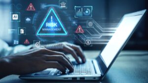 Risk automation dashboard on a laptop shows digital risk alerts and business review data