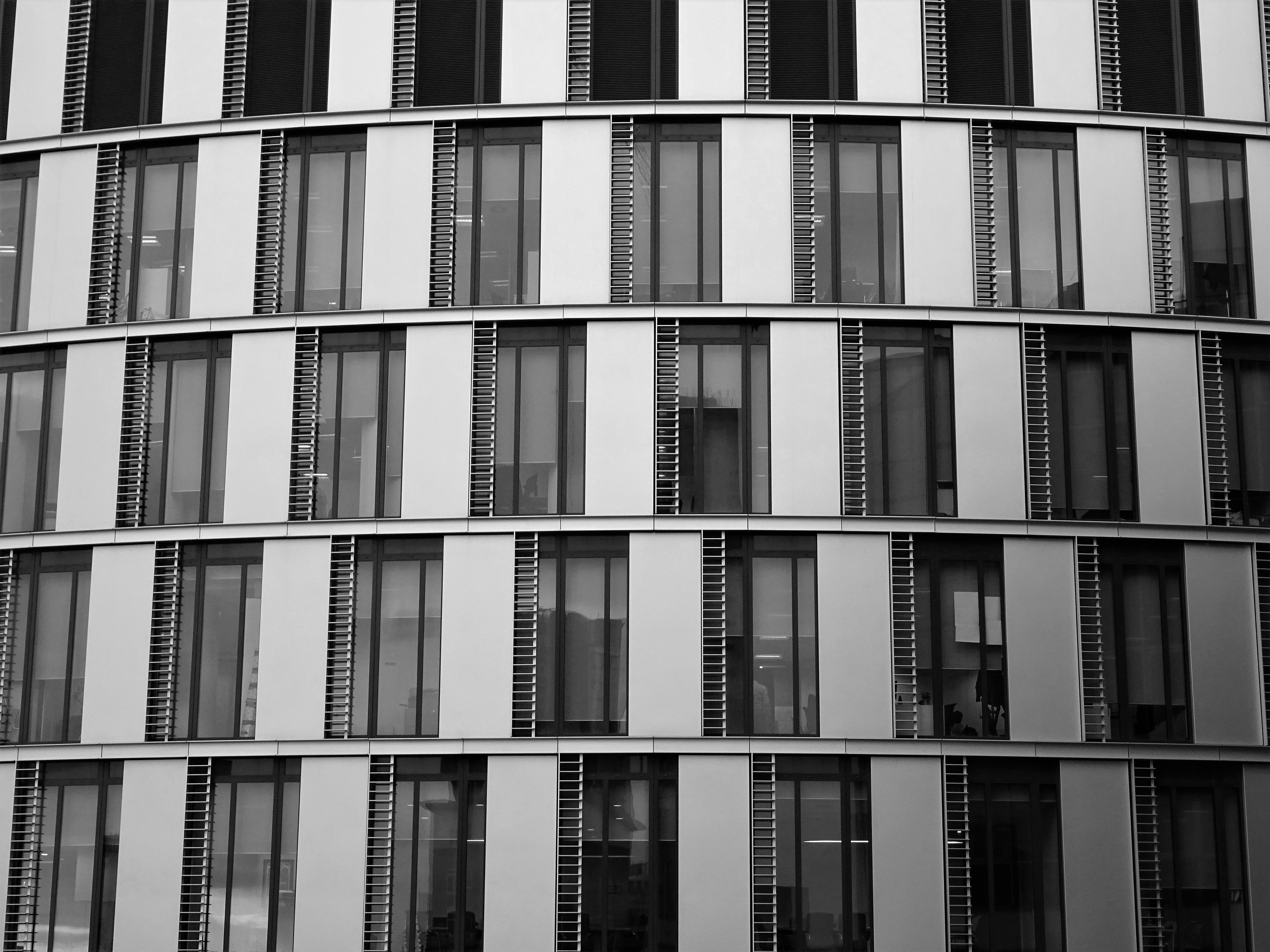 Close-up of a contemporary office building exterior with glass and steel elements