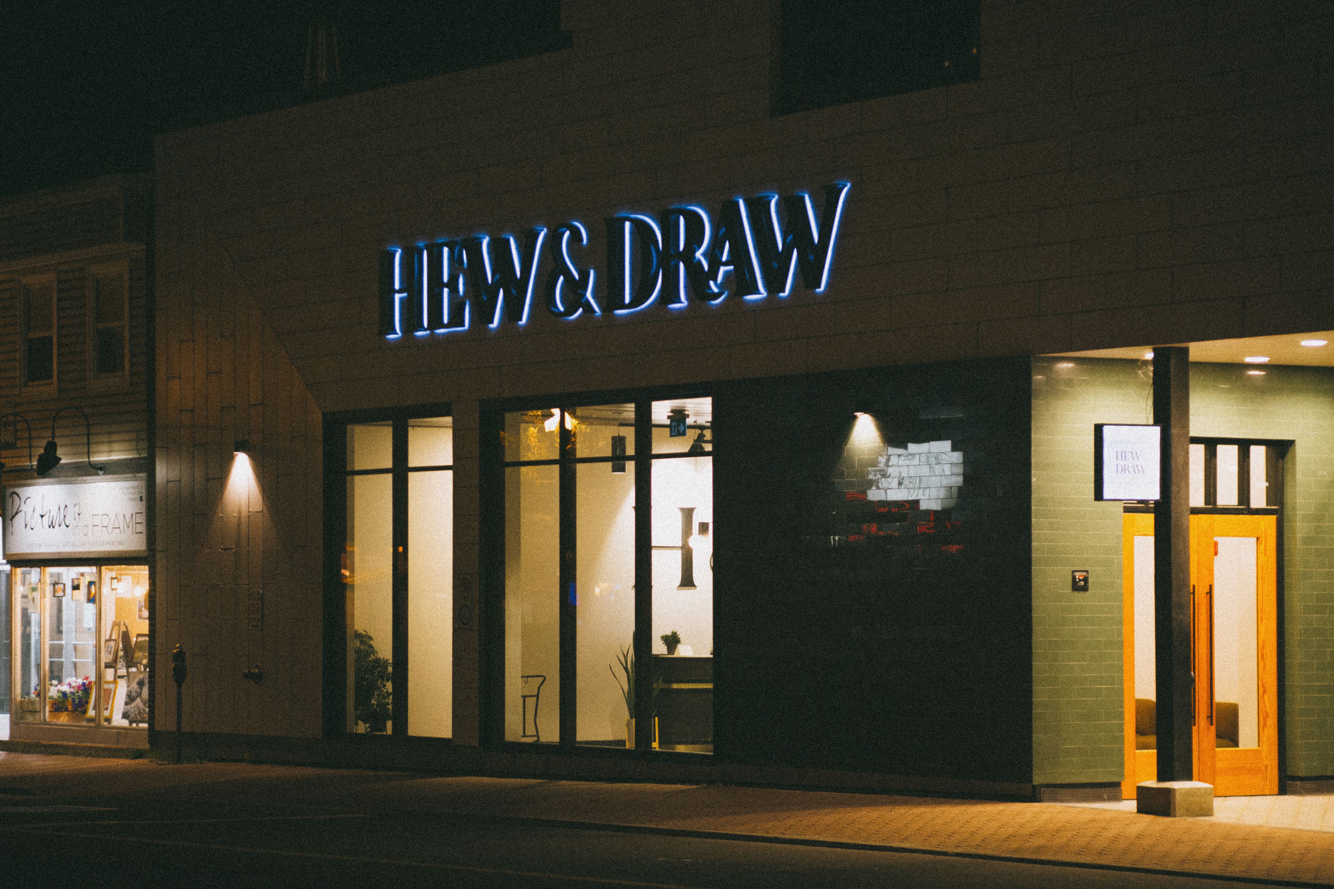 Night view of a storefront with illuminated signage and modern design
